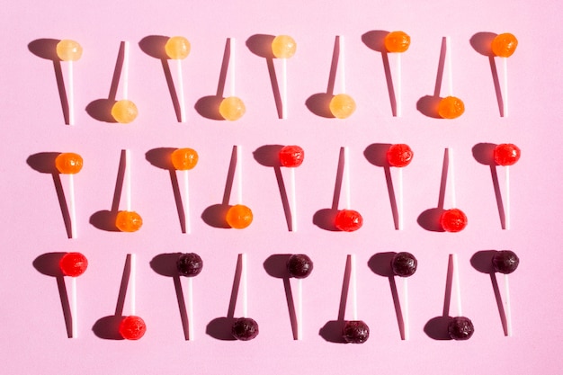 Top view lollipops on pink background