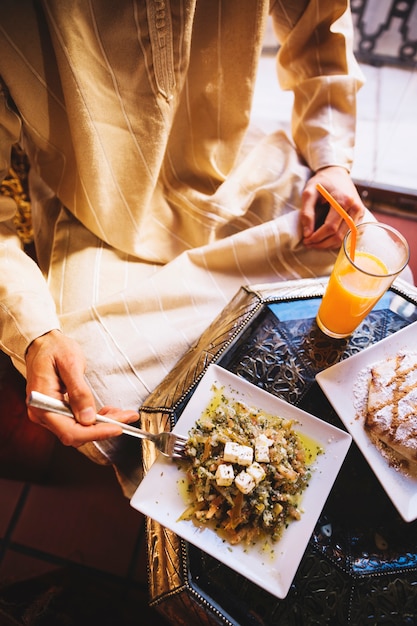 Top view of man eating in arab restaurant