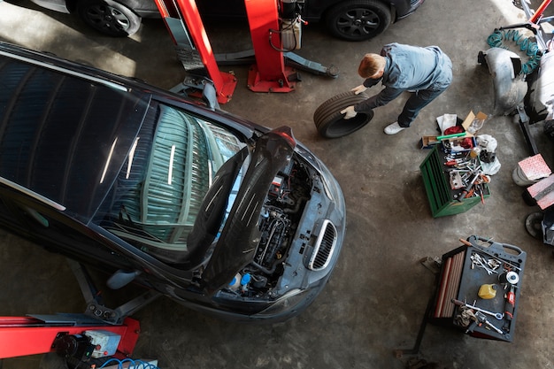 Free Photo top view man repairing car