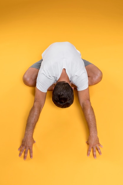 Free photo top view man stretching in yoga pose