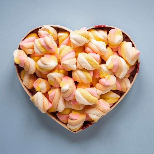 Free photo top view of marshmallow in heart shaped bowl