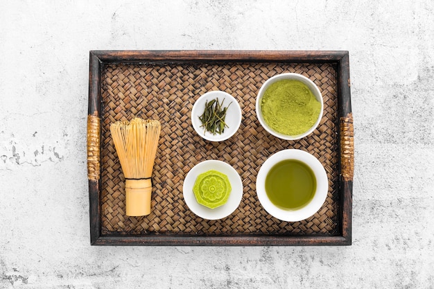 Free photo top view matcha tea concept with bamboo whisk