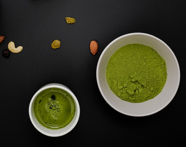 Free Photo top view of matcha tea powder in bowl with assortment of nuts