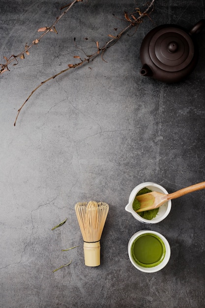 Free Photo top view of matcha tea with bamboo whisk and copy space