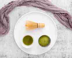 Free photo top view matcha tea with bamboo whisk