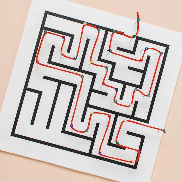 Free Photo top view maze on paper with thread