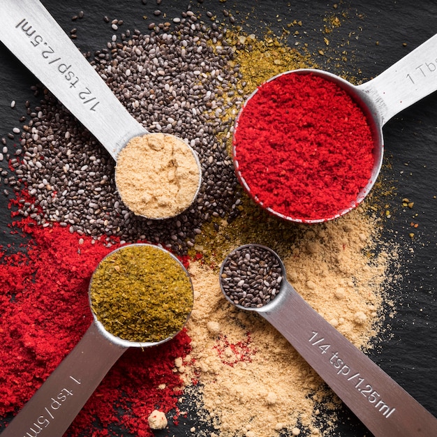 Free Photo top view measuring spoons with spices