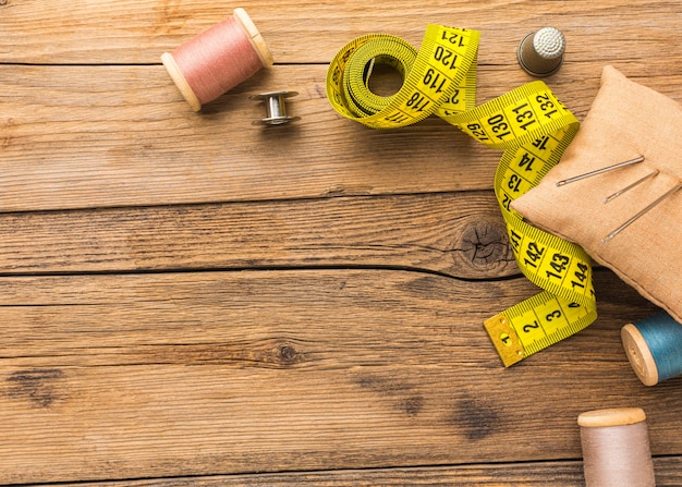 Top view of measuring tape with copy space and thread