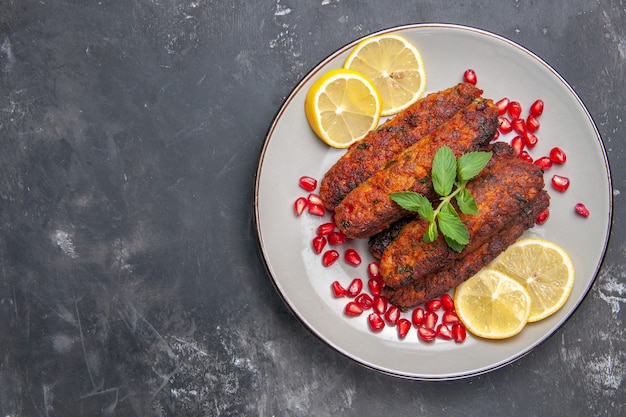 Top view meat cutlets long formed with lemon slices