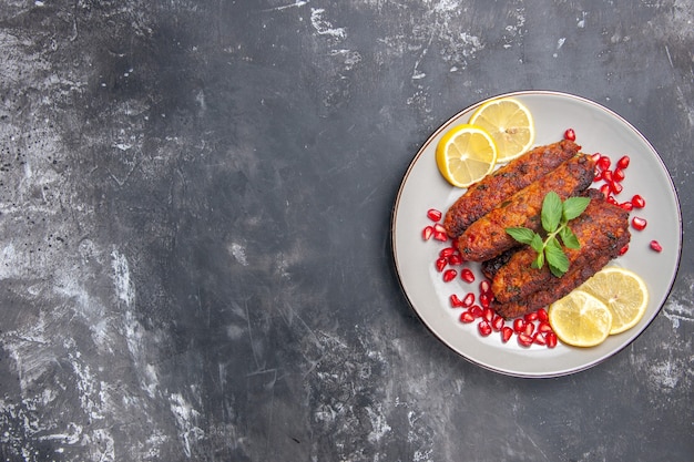 Top view meat cutlets long formed with lemon slices