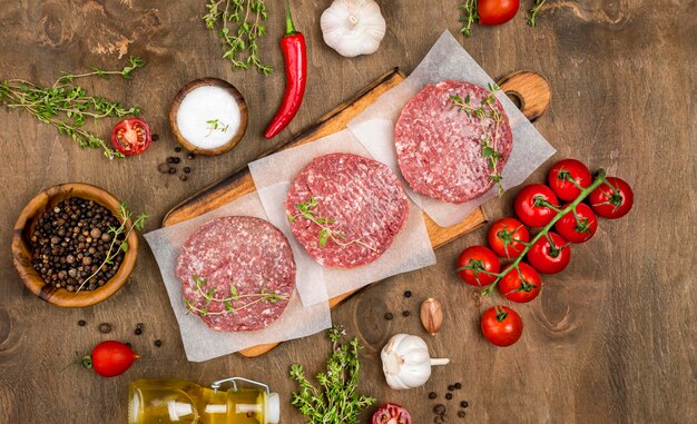 Top view of meat with herbs and oil