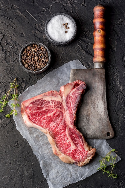 Free photo top view of meat with salt and spices on slate