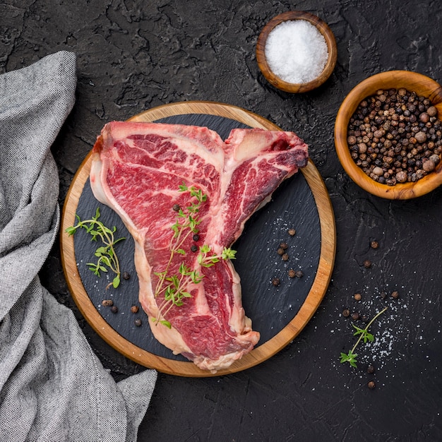 Top view of meat with spices and salt