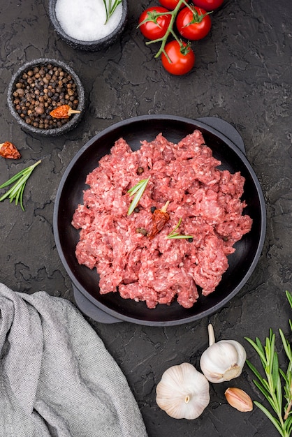 Top view of meat with tomatoes and spices