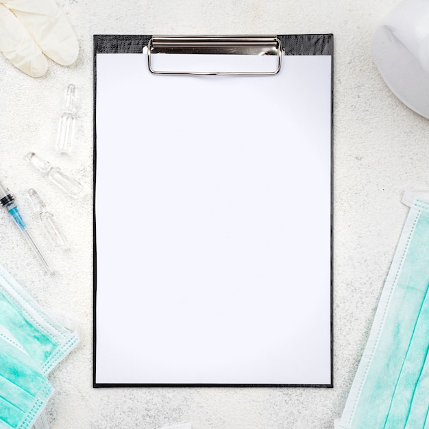 Top view medical desk composition with empty clipboard