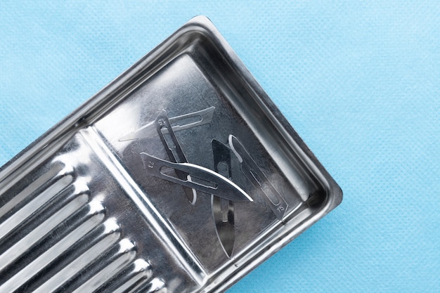 Top view of medical scalpel blades in tray