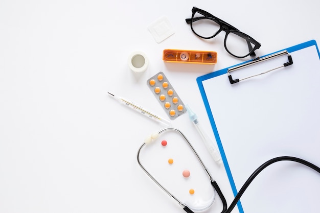 Top view medicine tablets with eyeglasses on the table