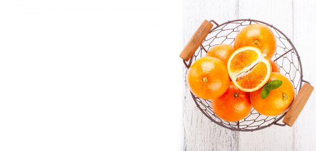 Top view of metallic basket with oranges