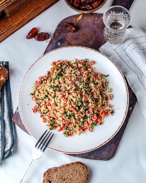 Top view minced vegetables colorful vitamine riched inside white plate on the light floor