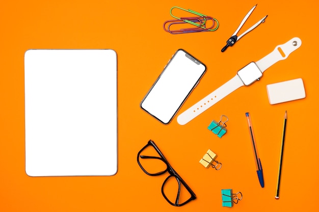 Top view mockup devices with office supplies