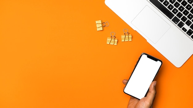 Free Photo top view mockup smartphone with orange background