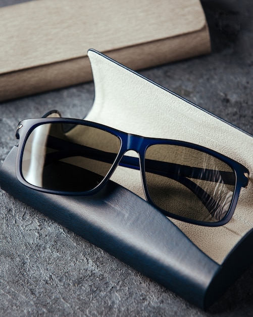 A top view modern blue sunglasses on the grey background isolated vision spectacles elegance