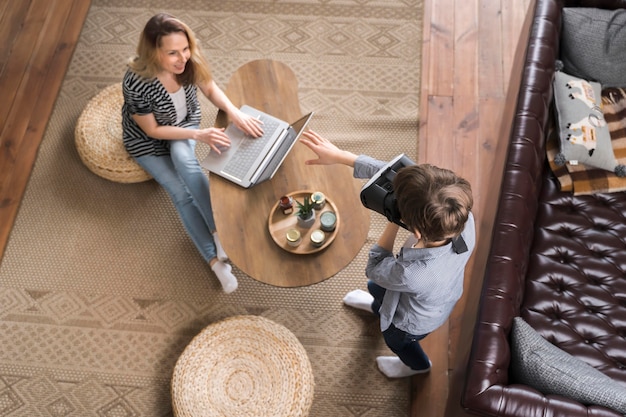 Top view mother enjoying work from home