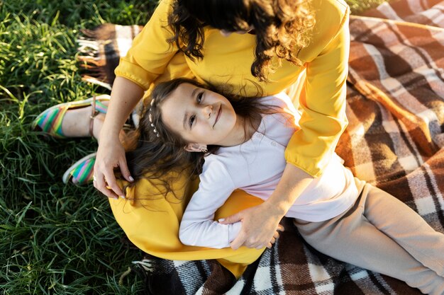 Top view mother holding smiley girl