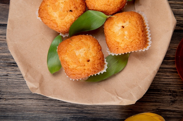 Top view of muffins on a craft brown paper on rustic