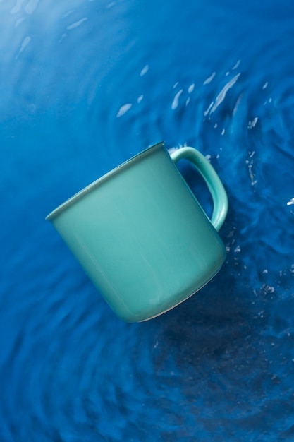 Free Photo top view over mug floating on water