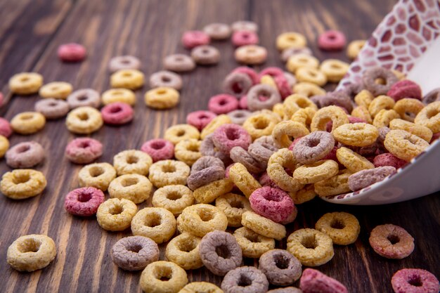 Top view of multicolored and loop cereals isolated on a wooden surface