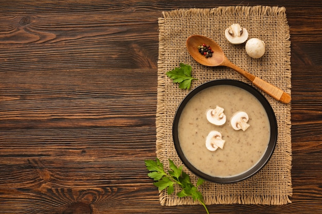 Top view mushrooms bisque and spoon with copy space