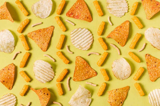 Free photo top view of nacho chips with potato chips and cheesy puffs