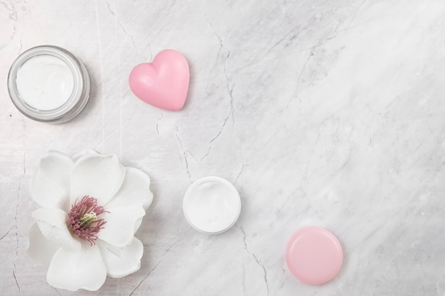 Top view of natural body cream on marble background