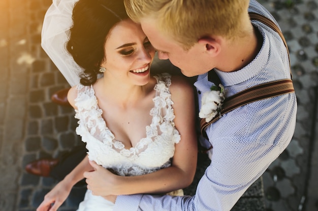 Free Photo top view of newlyweds laughing and hugging