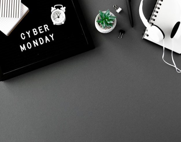 Top view of notebook with clock and headphones for cyber monday