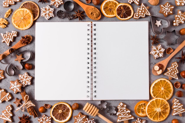 Top view of notebook with dried citrus and gingerbread