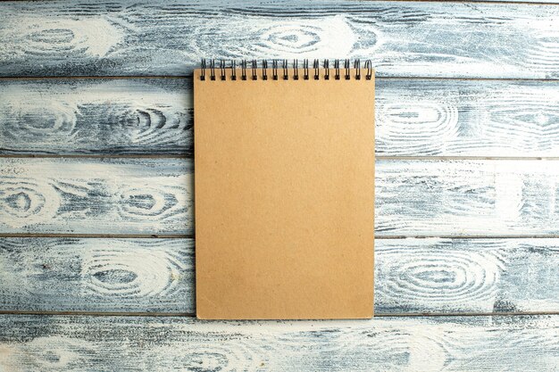 Top view notebook on wooden background