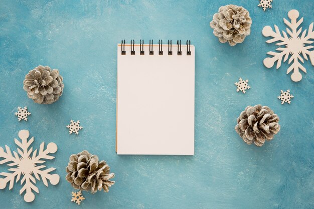 Free Photo top view notepad surrounded by conifer pine cones