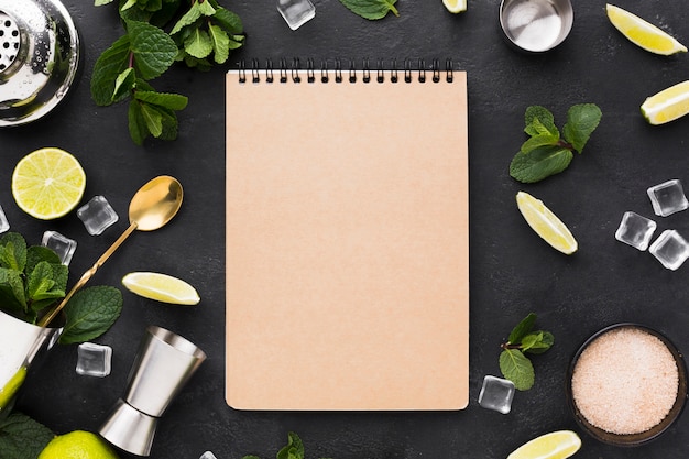 Top view of notepad with cocktail essentials