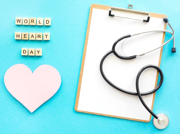 Free Photo top view of notepad with stethoscope and paper heart