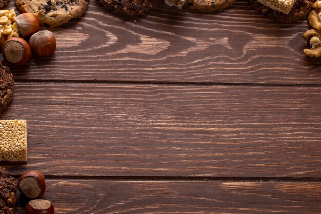 Top view of nuts and cookies with copy space on wooden