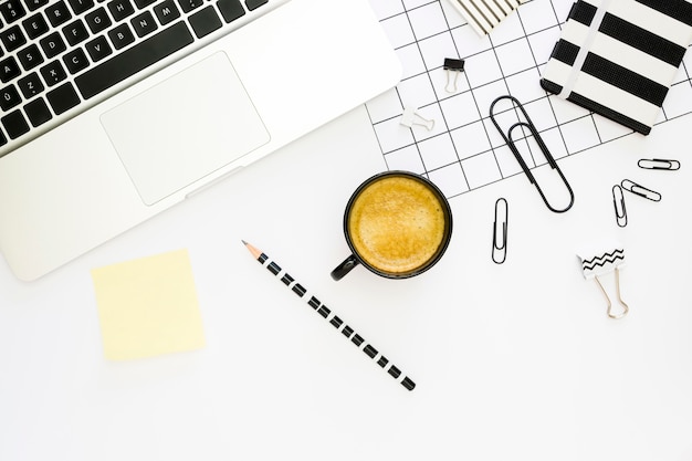 Free photo top view of office stationery with coffee and laptop