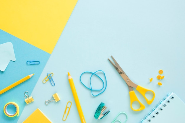 Top view of office stationery with copy space and scissors