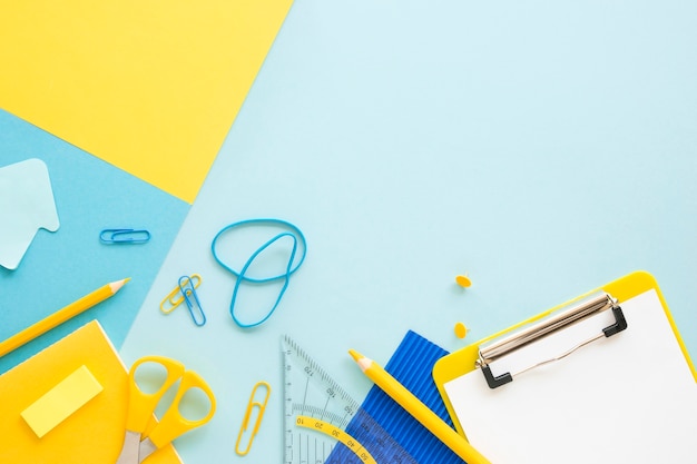 Top view of office stationery with notepad and elastic bands