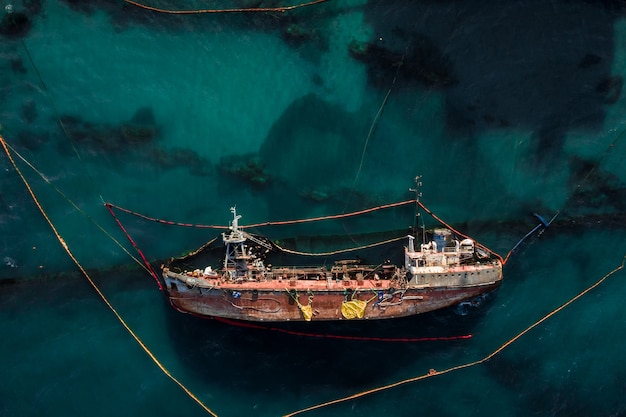 Free Photo top view of an old tanker that ran aground and overturned