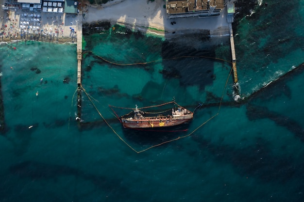 Top view of an old tanker that ran aground and overturned