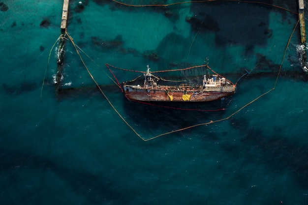 Free Photo top view of an old tanker that ran aground and overturned