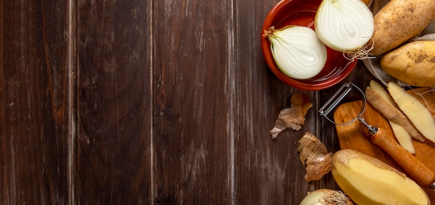 Top view of onions and peeled potatoes