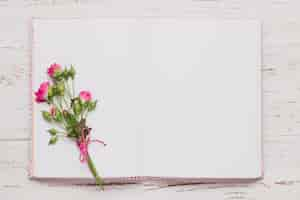 Free photo top view of open book with cute flowers